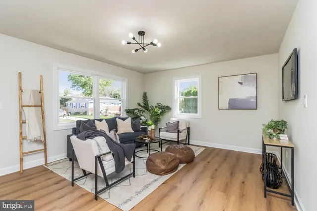 a living room with furniture and a chandelier