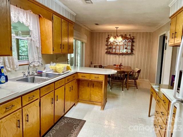 709 Green Road Rutherfordton, NC 28139 - Photo 23 of 46 a kitchen with stainless steel appliances granite countertop sink window and chairs