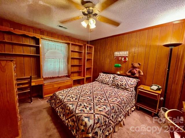 709 Green Road Rutherfordton, NC 28139 - Photo 30 of 46 a bedroom with a bed and a chandelier