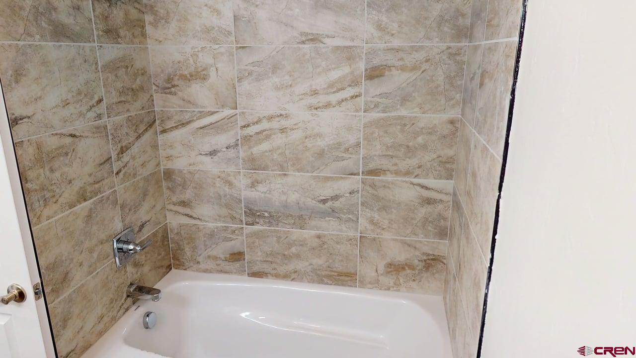 8714 Ridgetop Drive Alamosa, CO 81101 - Photo 14 of 18 a bathroom with a bathtub