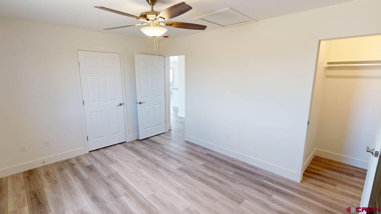8714 Ridgetop Drive Alamosa, CO 81101 - Photo 16 of 18 a view of an empty room with wooden floor