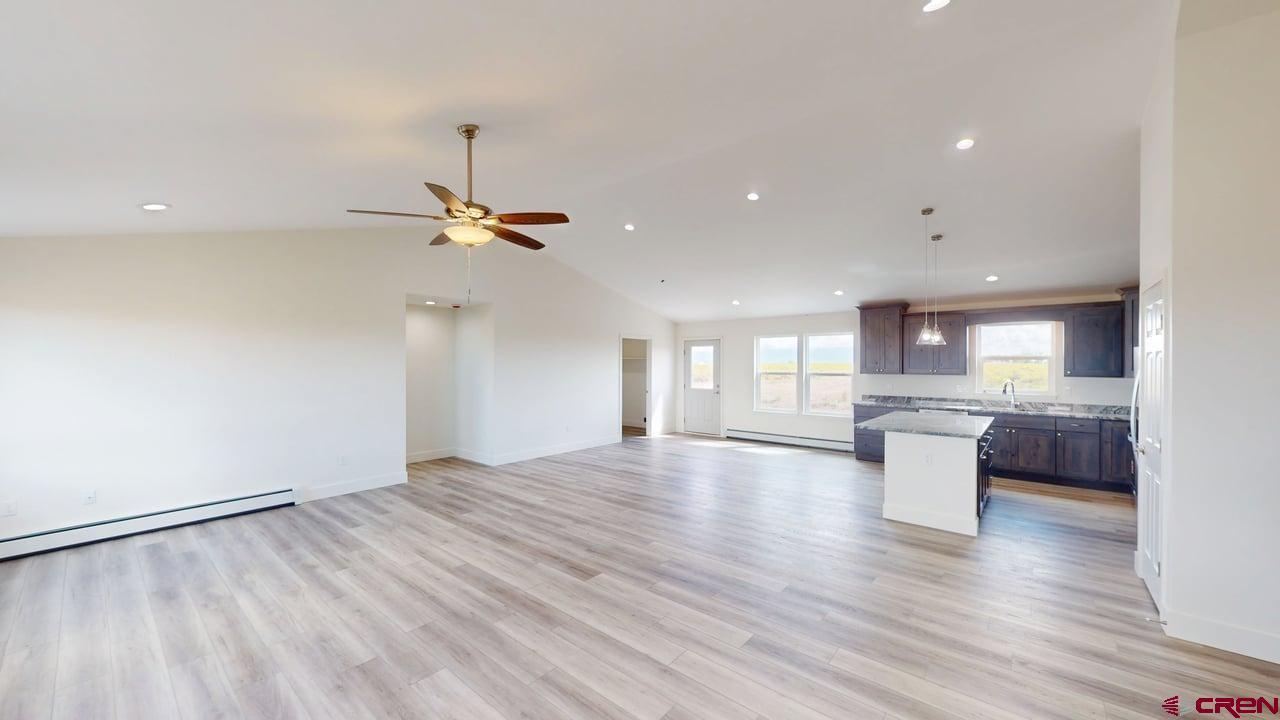 8714 Ridgetop Drive Alamosa, CO 81101 - Photo 5 of 18 a view of a living room a kitchen and a wooden floor