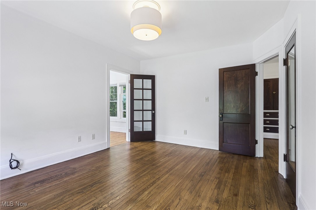 3075 Scarborough Road Cleveland, OH 44118 - Photo 26 of 46 Spare room with dark wood-style flooring and baseboards