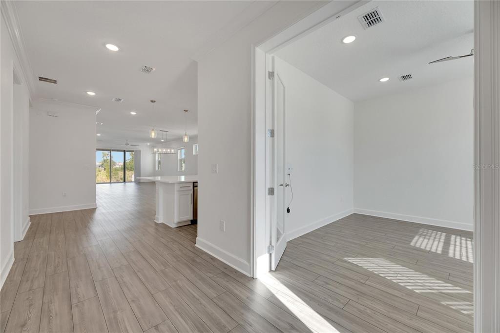 923 Signet Drive Apollo Beach, FL 33572 - Photo 12 of 84 a view of empty room with wooden floor