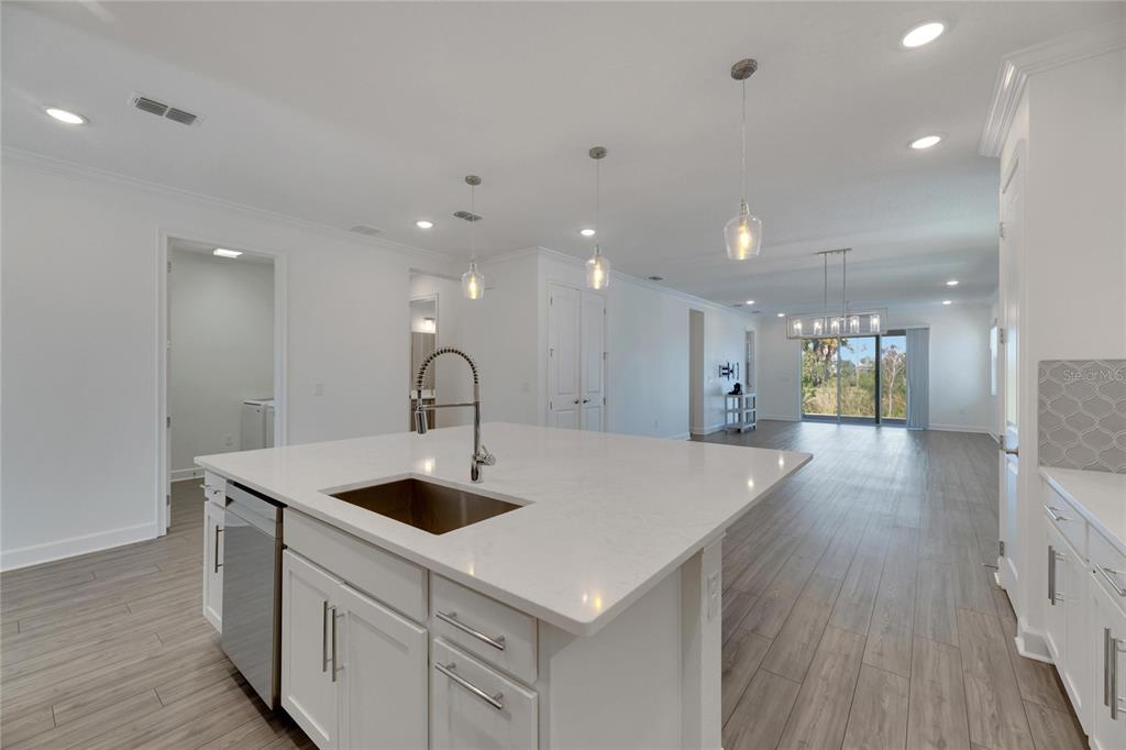 923 Signet Drive Apollo Beach, FL 33572 - Photo 14 of 84 a view of kitchen island a sink and wooden floor