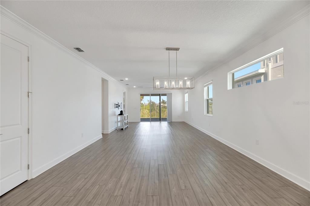 923 Signet Drive Apollo Beach, FL 33572 - Photo 19 of 84 a view of an empty room with wooden floor and a window