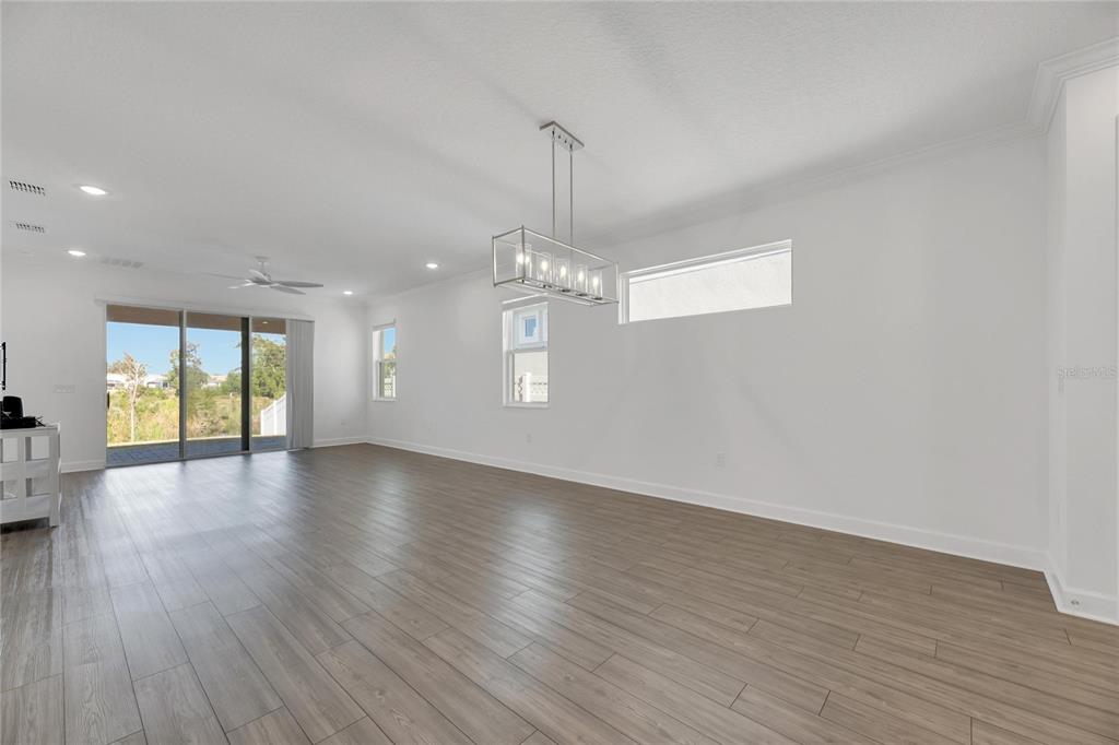 923 Signet Drive Apollo Beach, FL 33572 - Photo 26 of 84 a view of a room with wooden floor chandelier and windows