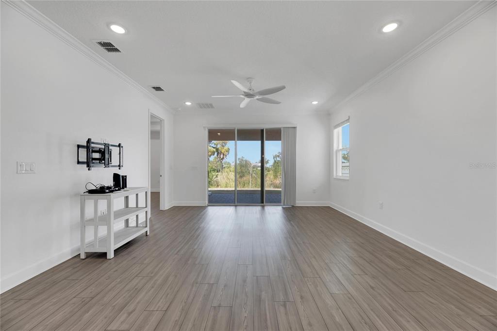 923 Signet Drive Apollo Beach, FL 33572 - Photo 28 of 84 a view of an empty room with a window and wooden floor