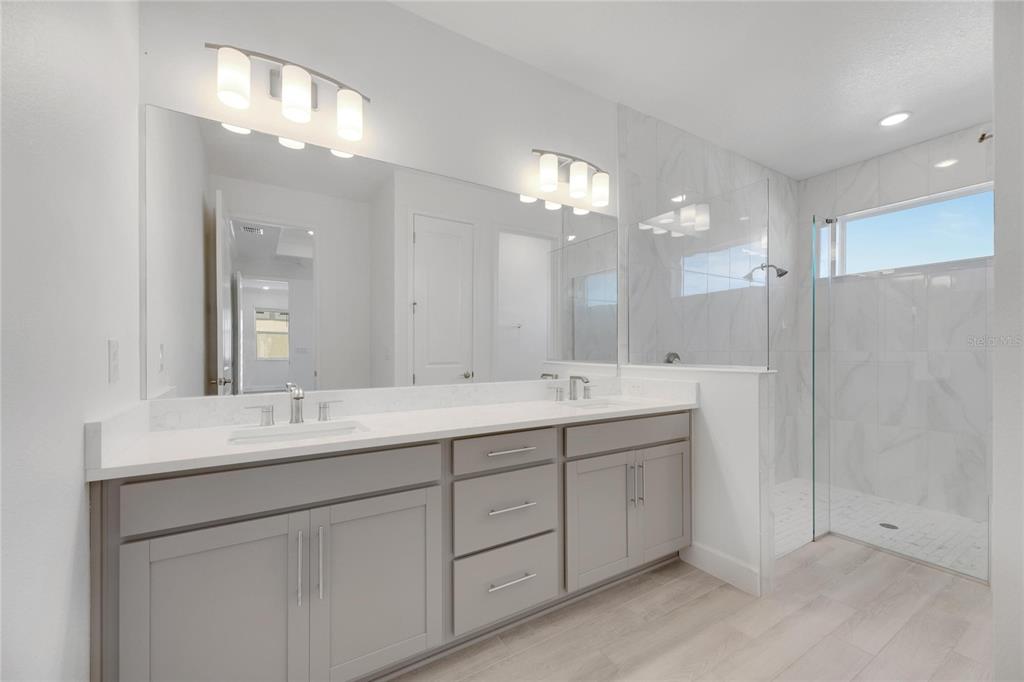 923 Signet Drive Apollo Beach, FL 33572 - Photo 37 of 84 a bathroom with double vanity sinks and a mirror