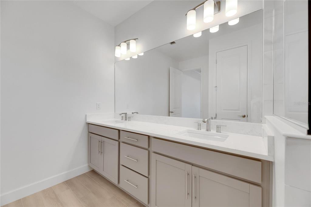 923 Signet Drive Apollo Beach, FL 33572 - Photo 39 of 84 a bathroom with a double vanity sink and a mirror