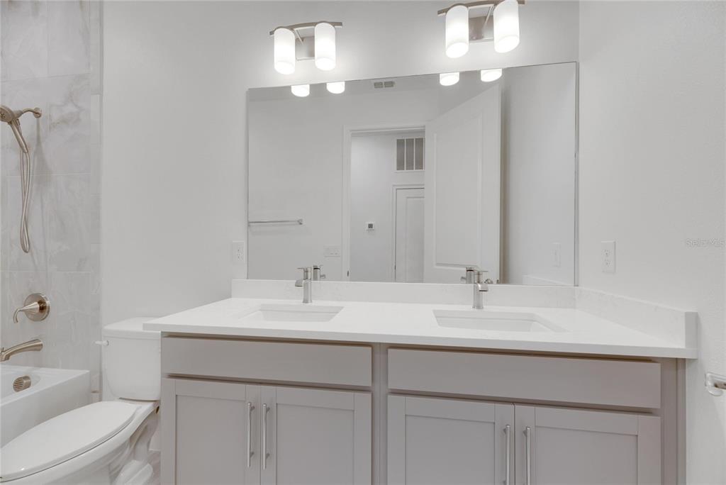 923 Signet Drive Apollo Beach, FL 33572 - Photo 40 of 84 a bathroom with a sink a toilet and a mirror