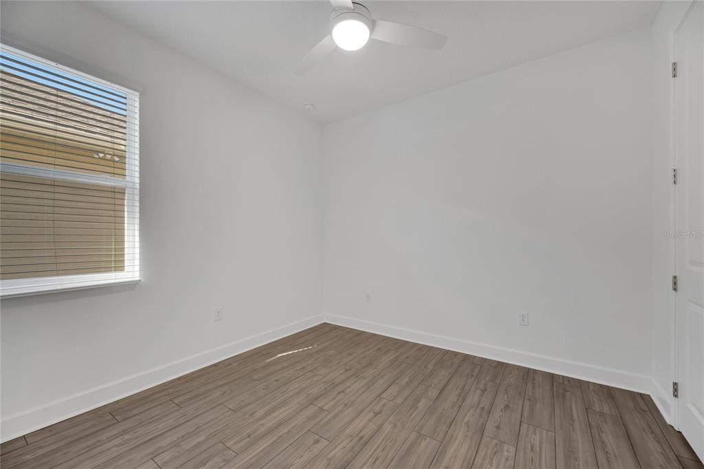 923 Signet Drive Apollo Beach, FL 33572 - Photo 43 of 84 a view of an empty room with wooden floor and a window