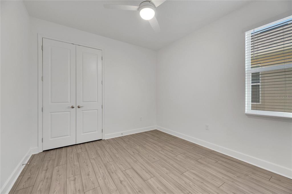 923 Signet Drive Apollo Beach, FL 33572 - Photo 47 of 84 a view of a room with wooden floor and white walls