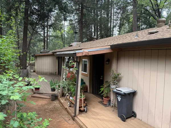 a balcony with wooden floor and outdoor seating