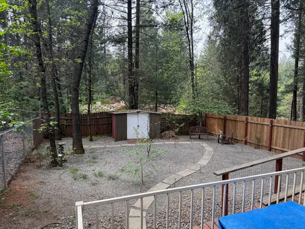 a view of a house with a yard and sitting area