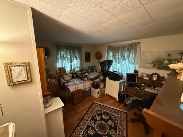 a kitchen with stainless steel appliances granite countertop a sink window and wooden floor