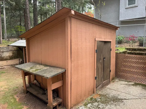 a view of a house with backyard and sitting area