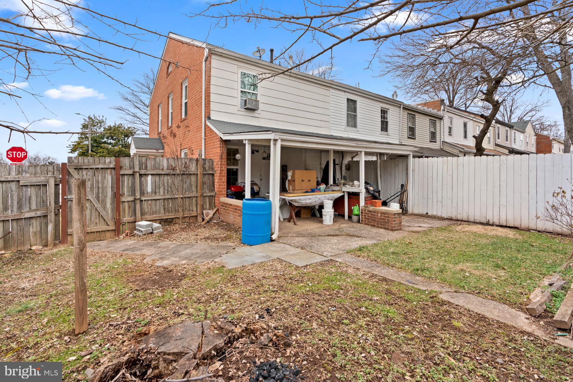 9315 Byrd Drive Manassas, VA 20110 - Photo 26 of 27 a view of a patio with table and chairs potted plants and wooden fence