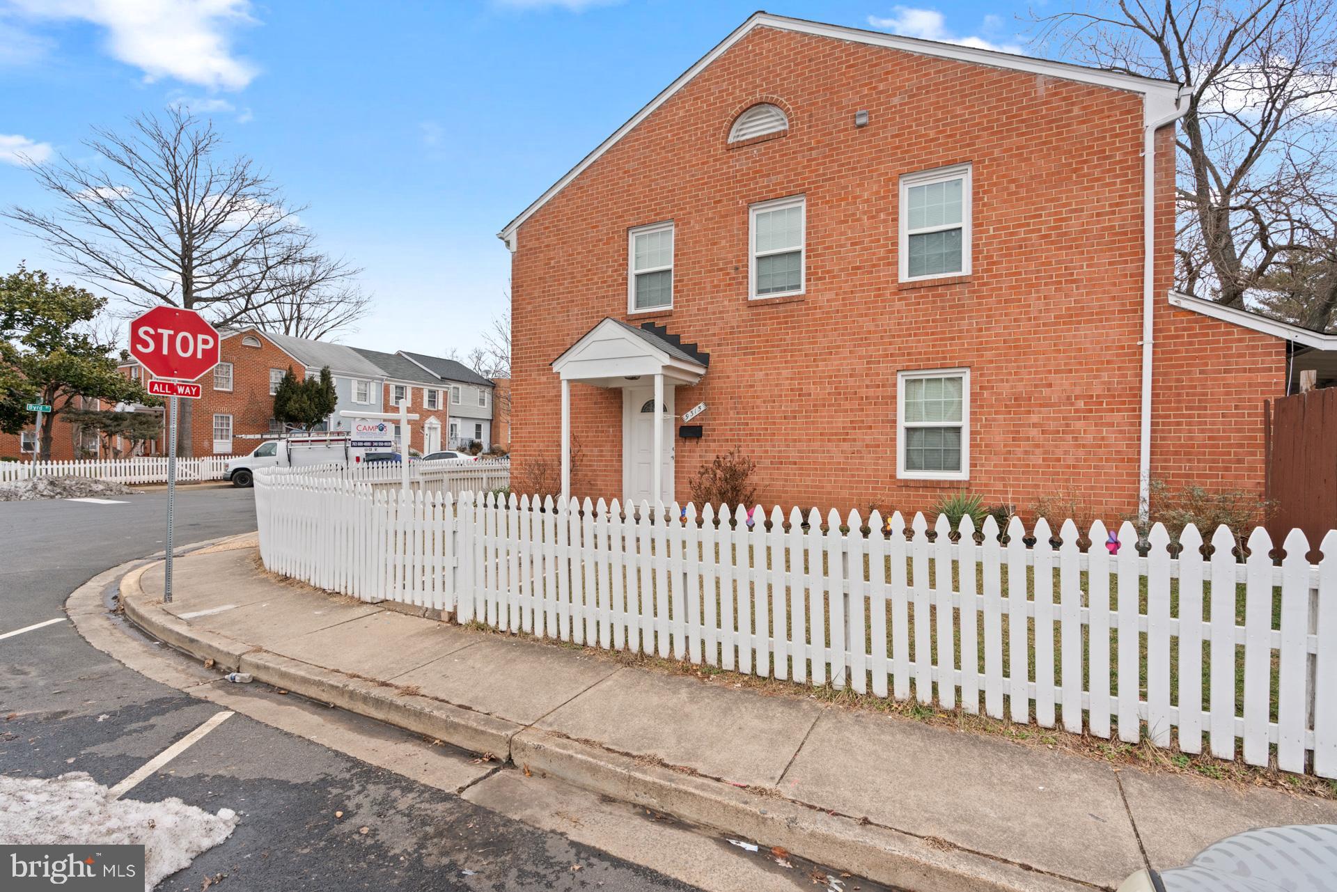 9315 Byrd Drive Manassas, VA 20110 - Photo 3 of 27 a front view of a brick house with large windows