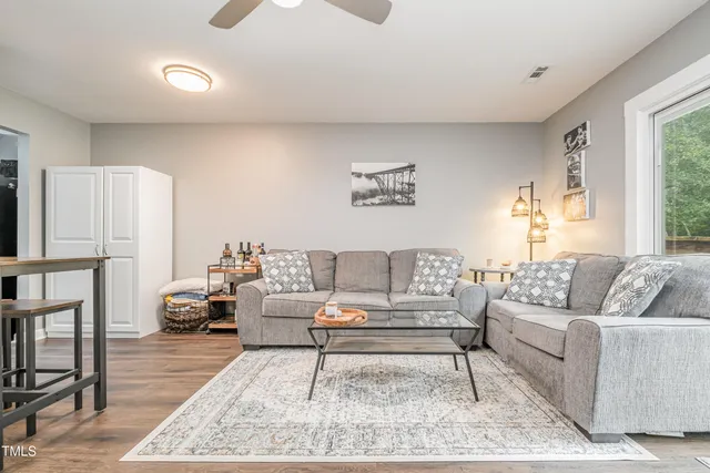 a living room with furniture and a rug