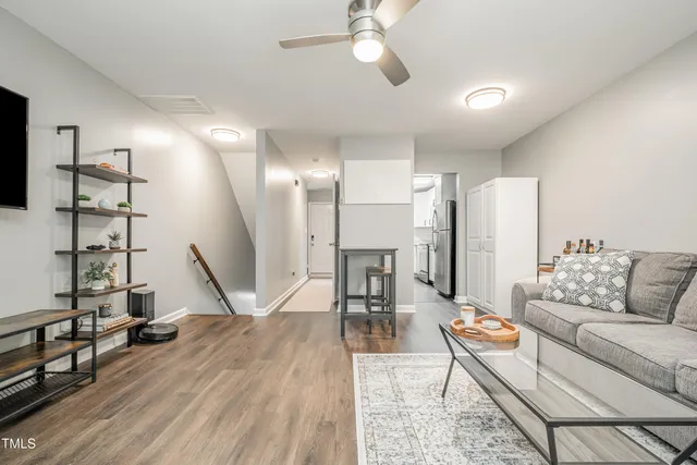a living room with furniture and a wooden floor