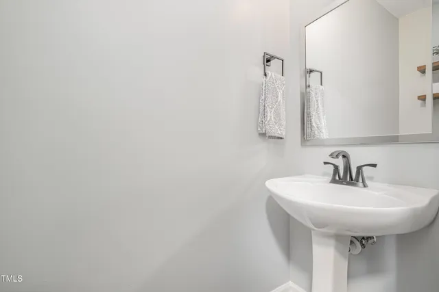 a bathroom with a sink a mirror and vanity