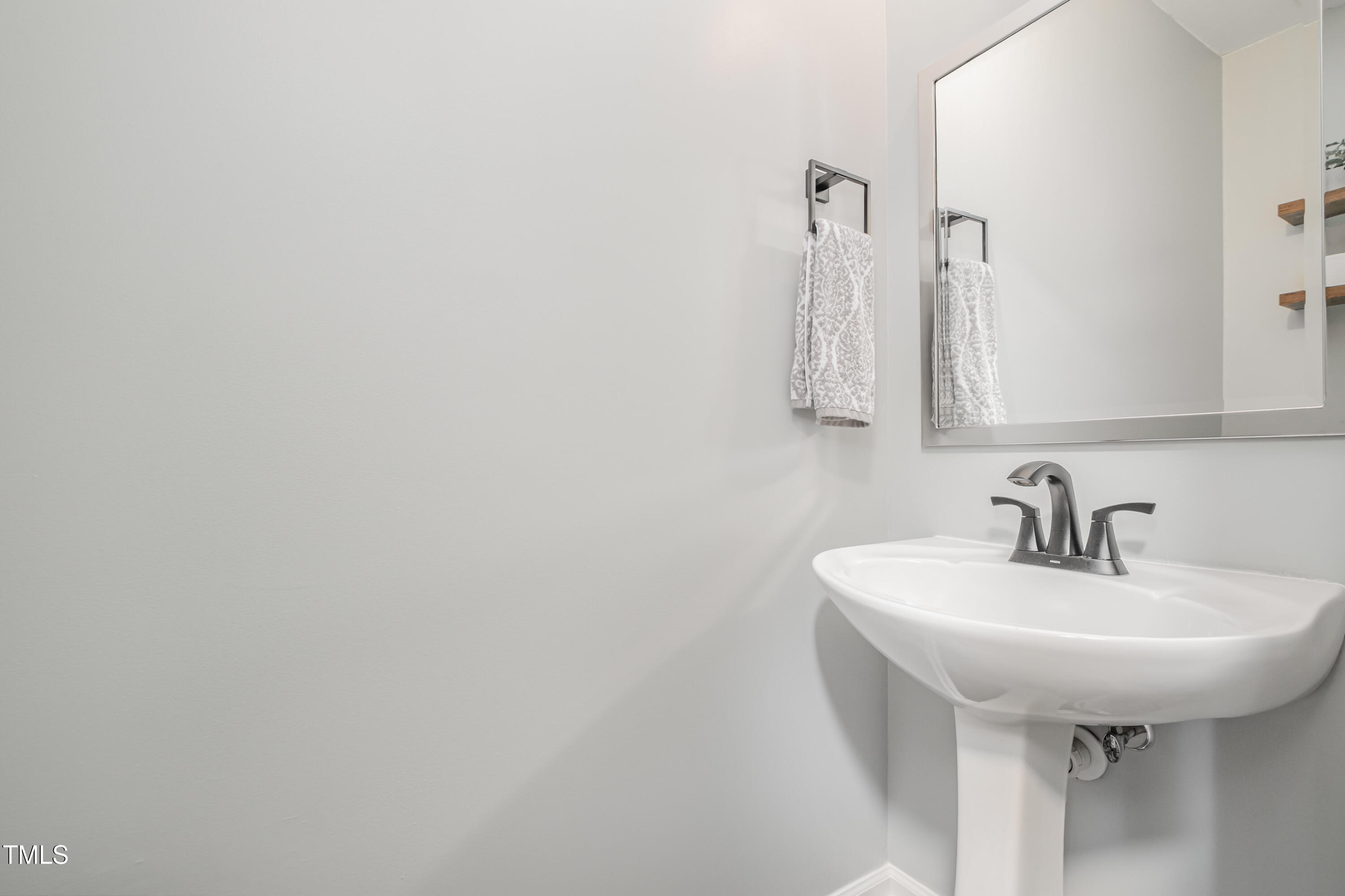932 South 5th Street Mebane, NC 27302 - Photo 14 of 29 a bathroom with a sink a mirror and vanity