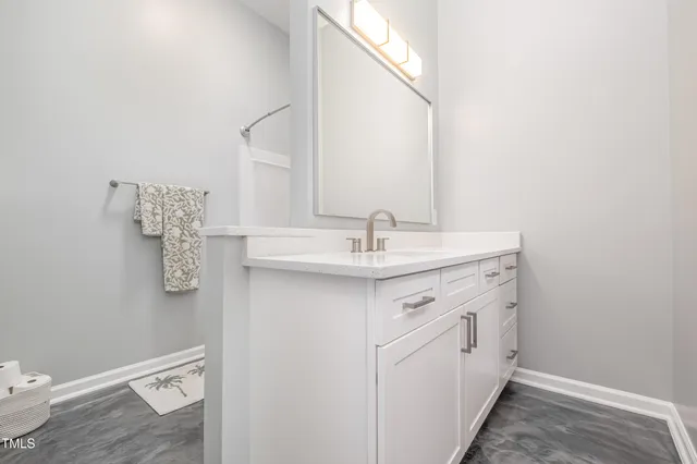 a spacious bathroom with a sink a toilet and mirror