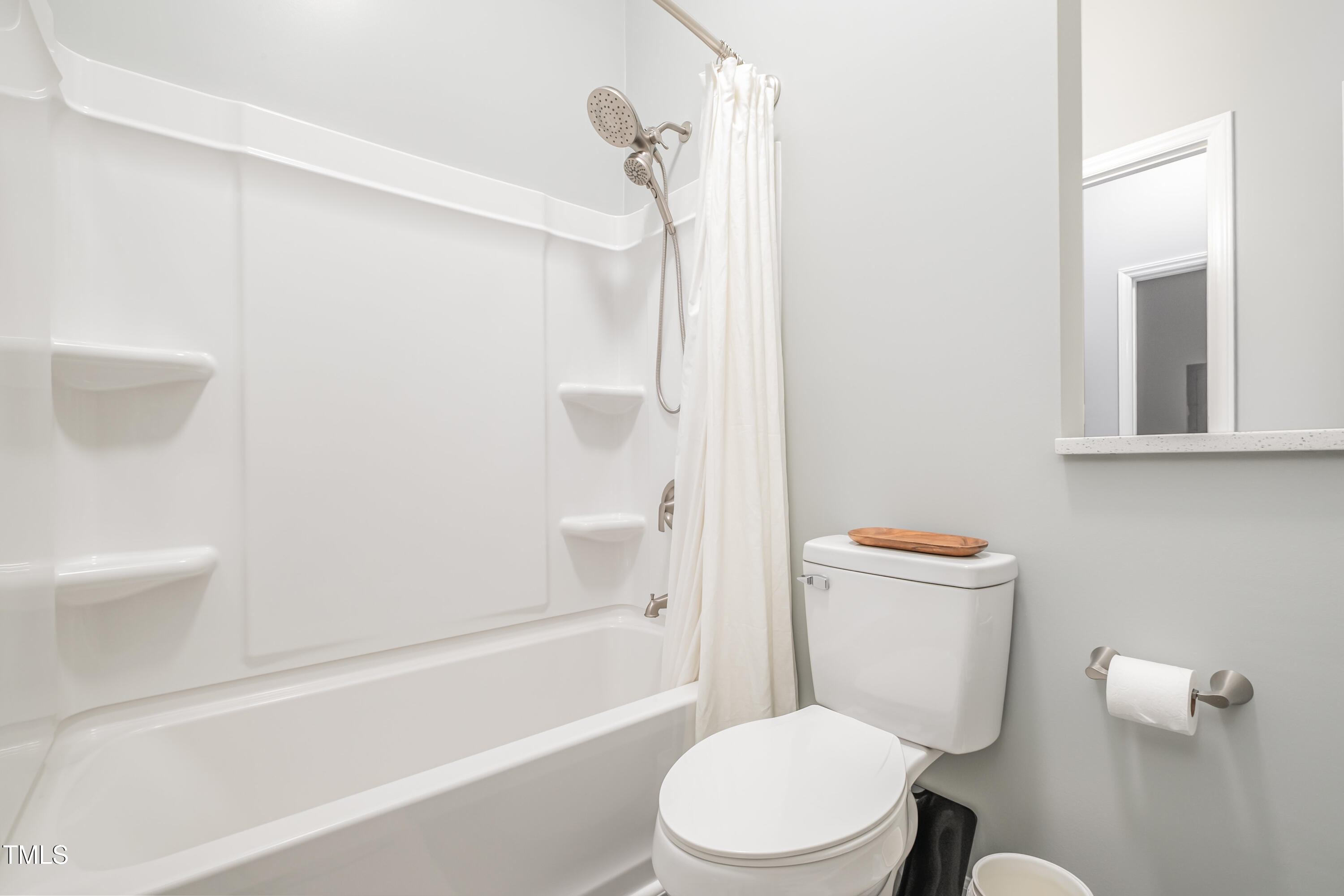 932 South 5th Street Mebane, NC 27302 - Photo 22 of 29 a white toilet sitting next to a bath tub