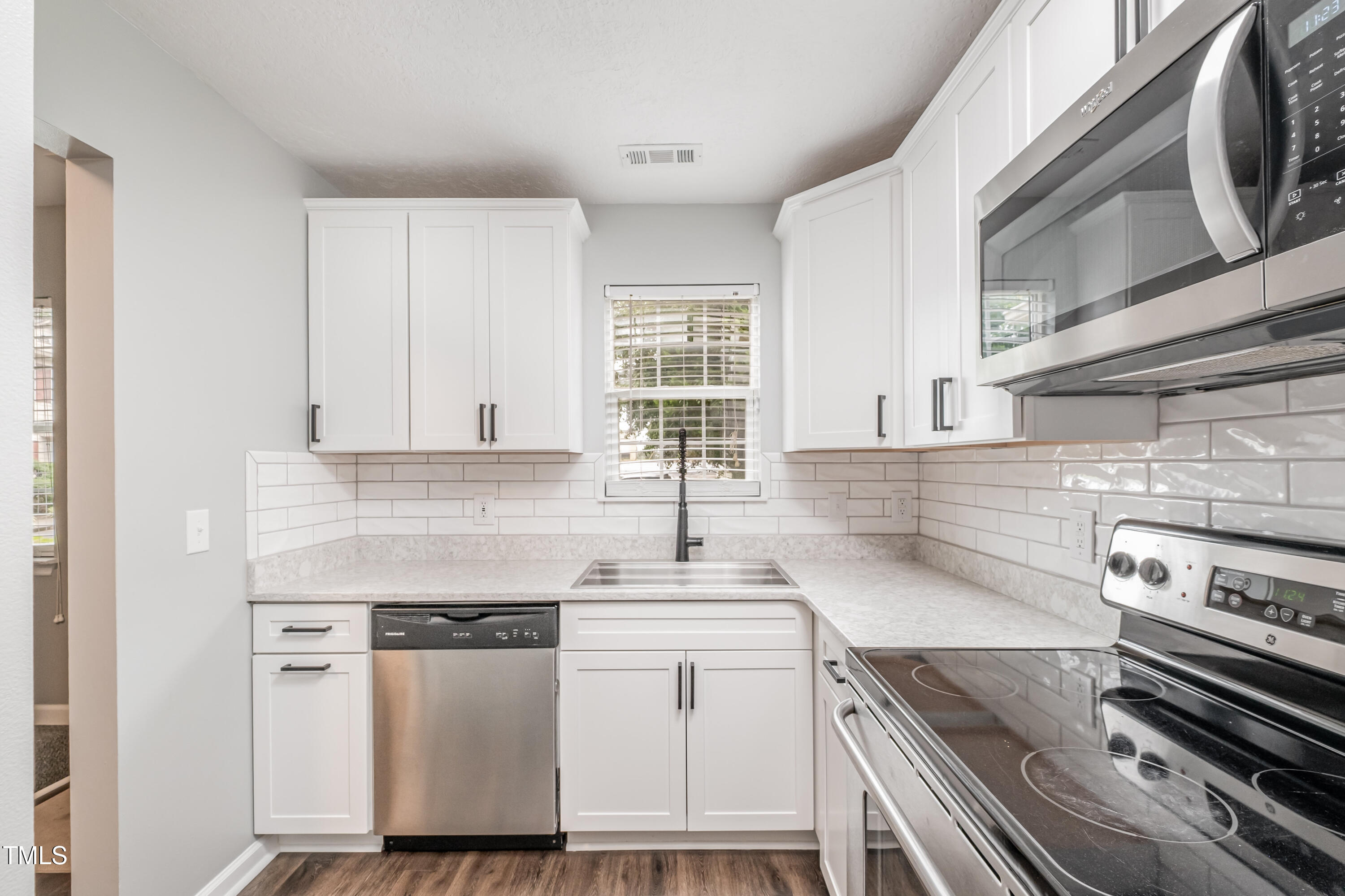 932 South 5th Street Mebane, NC 27302 - Photo 8 of 29 a kitchen with a sink stove and cabinets