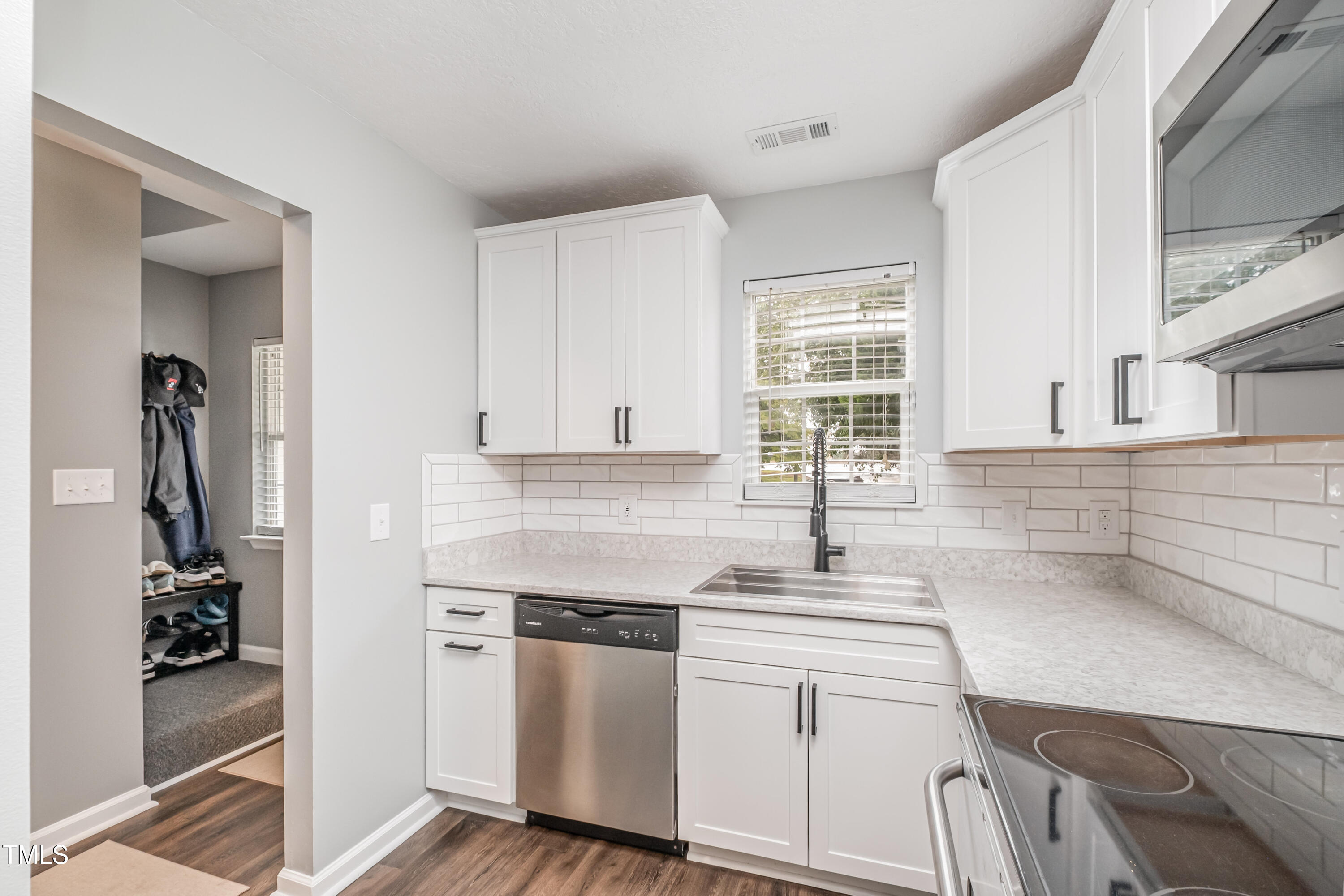 932 South 5th Street Mebane, NC 27302 - Photo 9 of 29 a kitchen with stainless steel appliances cabinets a sink and a window
