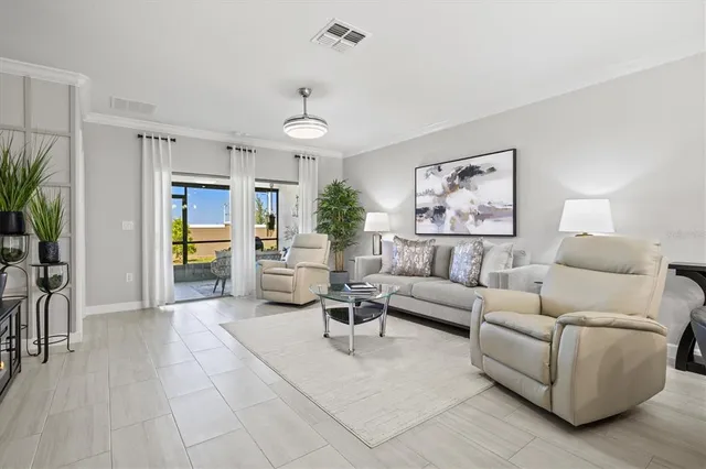 a living room with furniture and a large window