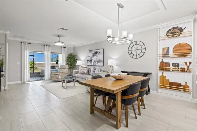 a view of a dining area with furniture and a chandelier