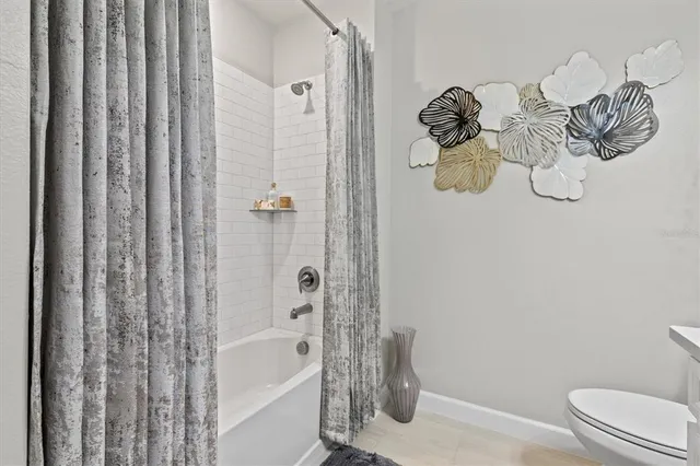a bathroom with a shower curtain and a sink
