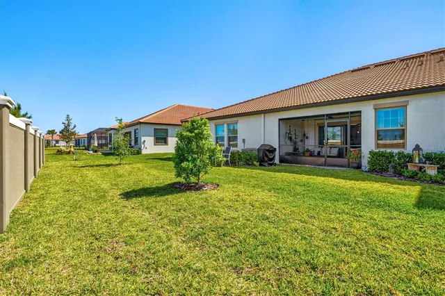 a view of an house with backyard space and balcony