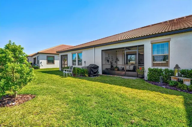 a view of a house with backyard and porch