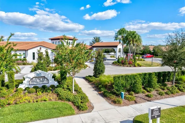 a view of a house with a yard and potted plants