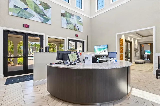 a view of a living room with furniture large window and flat screen tv