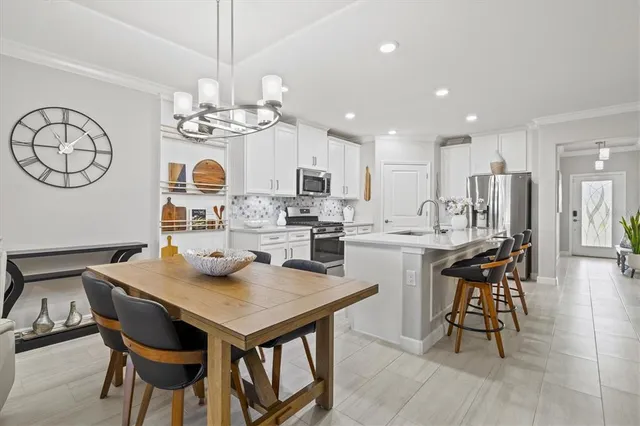 a view of kitchen with dining table and chairs