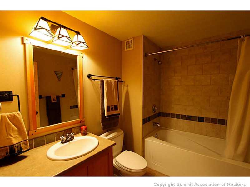 910 Copper Road, Unit 216 Copper Mountain, CO 80443 - Photo 11 of 18 a bathroom with a sink mirror vanity and toilet