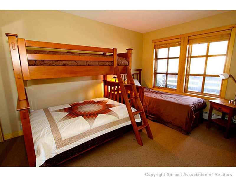 910 Copper Road, Unit 216 Copper Mountain, CO 80443 - Photo 10 of 18 a bedroom with a bed lamp and a window
