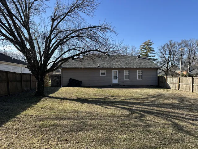 a front view of a house with a yard and a garage