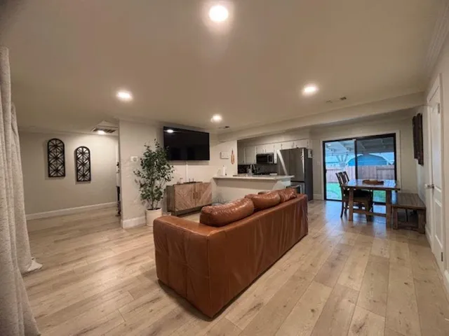 a living room with furniture and a ceiling fan