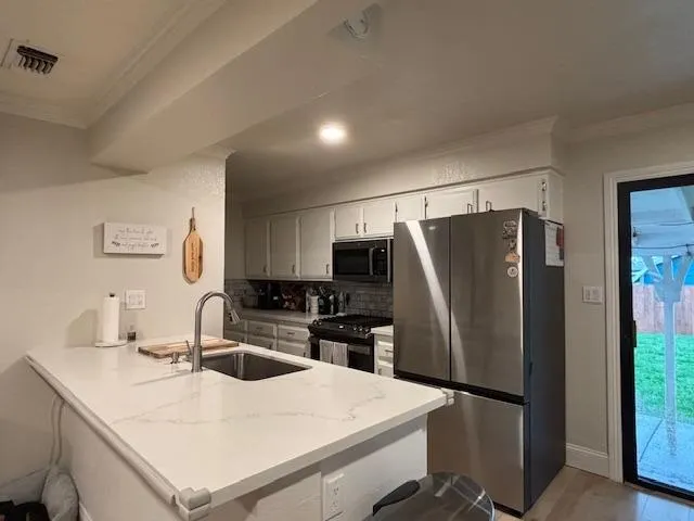 a view of a backyard with table and chairs with wooden fence