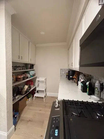 a kitchen with stainless steel appliances a refrigerator sink and microwave