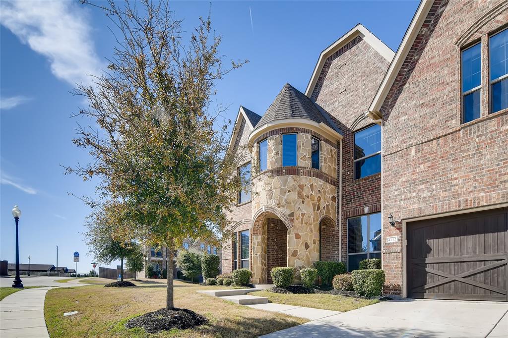 a front view of a building with a garden