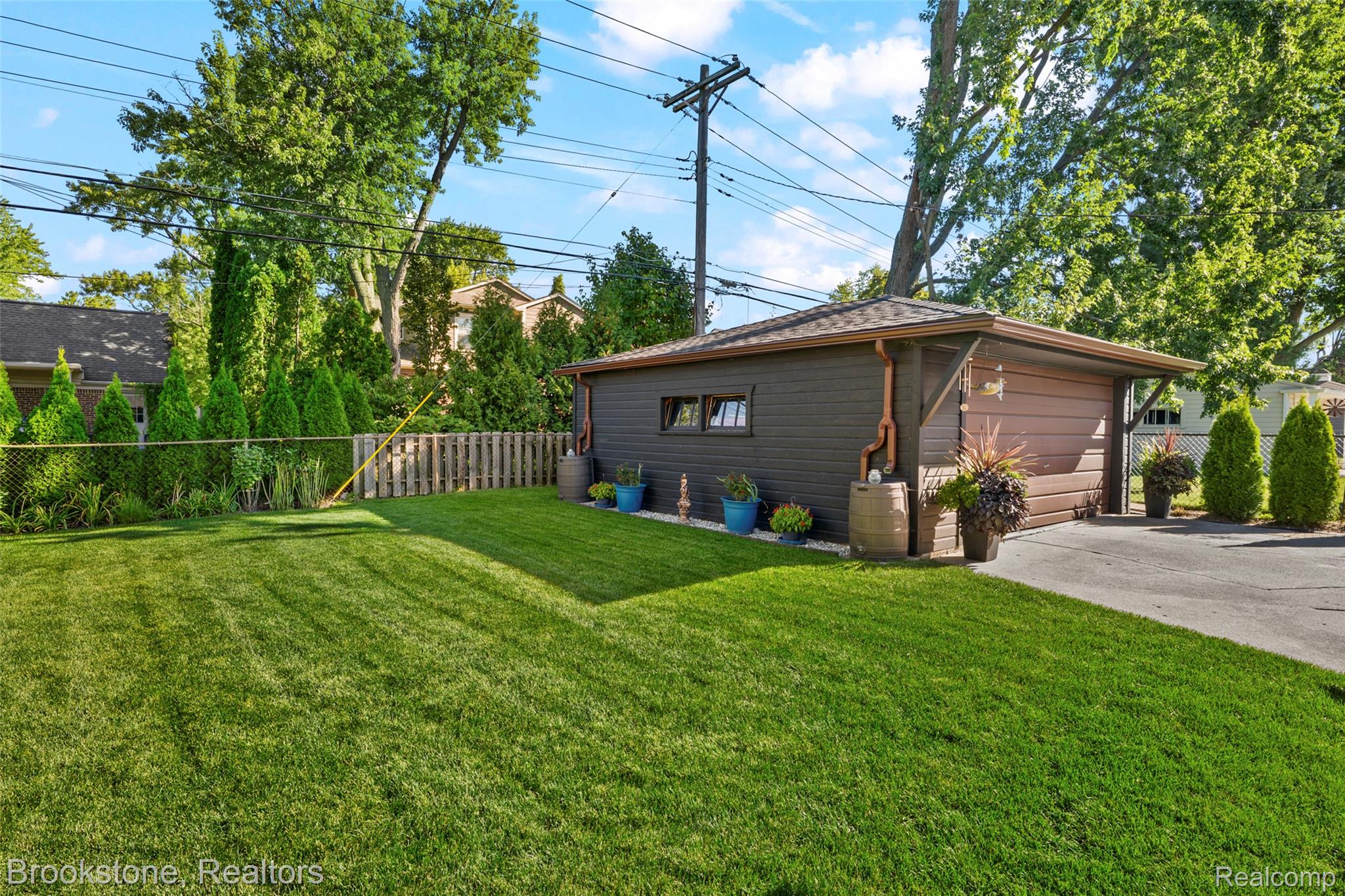 18474 Beverly Road Franklin, MI 48025 - Photo 24 of 38 View of luscious green (new sod in 2024) yard featuring a garage and an outbuilding