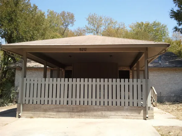 a view of a house with a fence