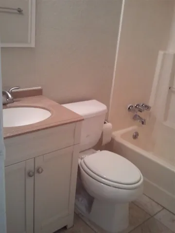 a white toilet sitting next to a bathroom sink