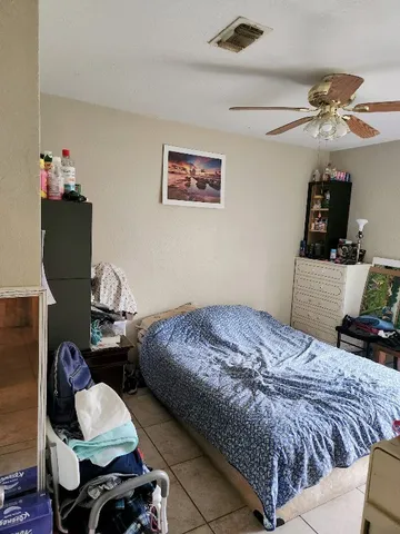 a bedroom with bed and a window